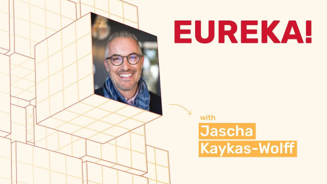 "EUREKA!" podcast with host Jascha Kaykas-Wolff. Man in glasses and scarf smiling.